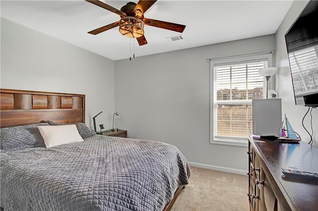 bedroom featuring visible vents, baseboards, a ceiling fan, and light colored carpet