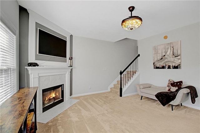 interior space with a fireplace, baseboards, and stairs