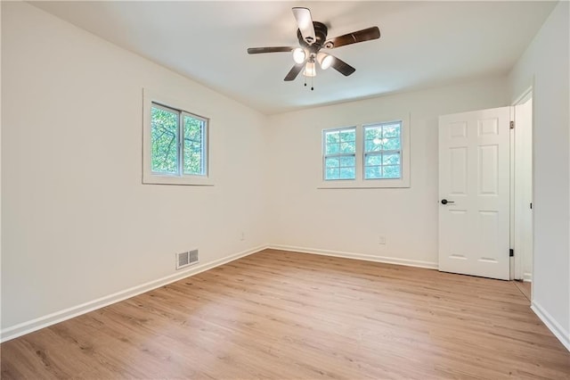 spare room with ceiling fan and light wood-type flooring