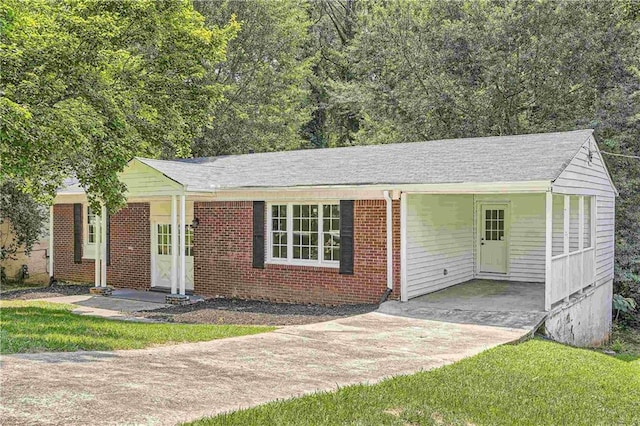 single story home with a carport and a front yard