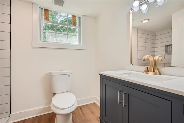 bathroom featuring hardwood / wood-style flooring, vanity, and toilet