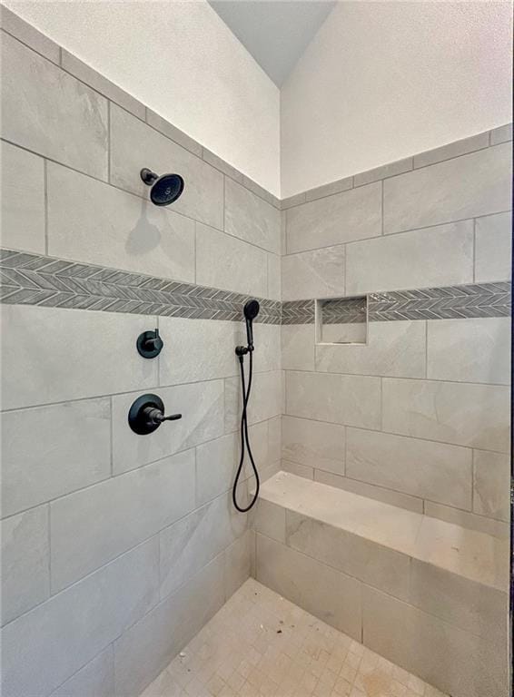 bathroom with a tile shower