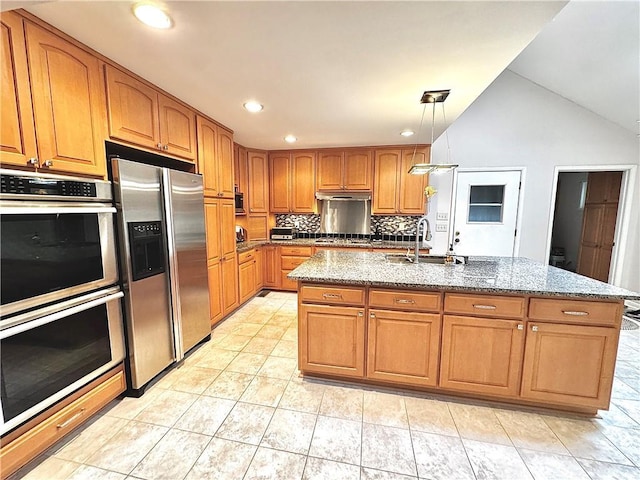 kitchen featuring a sink, light stone countertops, stainless steel appliances, under cabinet range hood, and backsplash