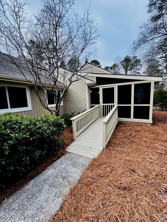 view of front facade featuring board and batten siding and a sunroom