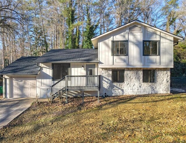 split level home with a garage and a front yard