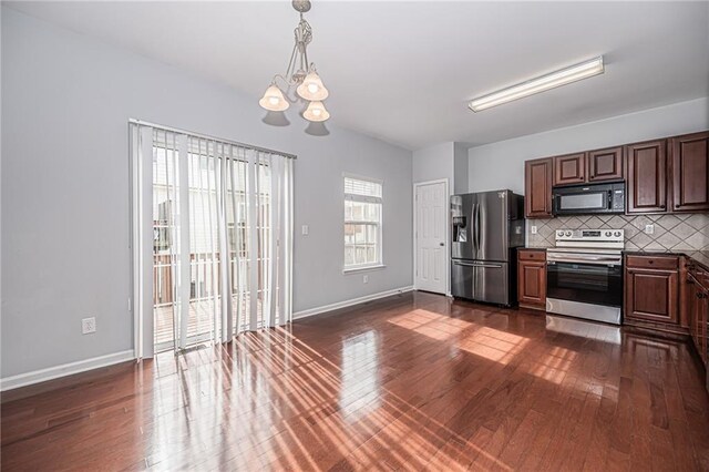 kitchen featuring backsplash, stainless steel appliances, a chandelier, and dark hardwood / wood-style flooring