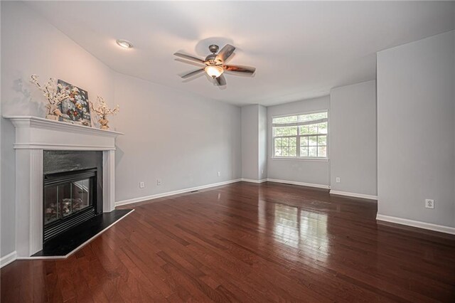 unfurnished living room with ceiling fan and dark hardwood / wood-style floors