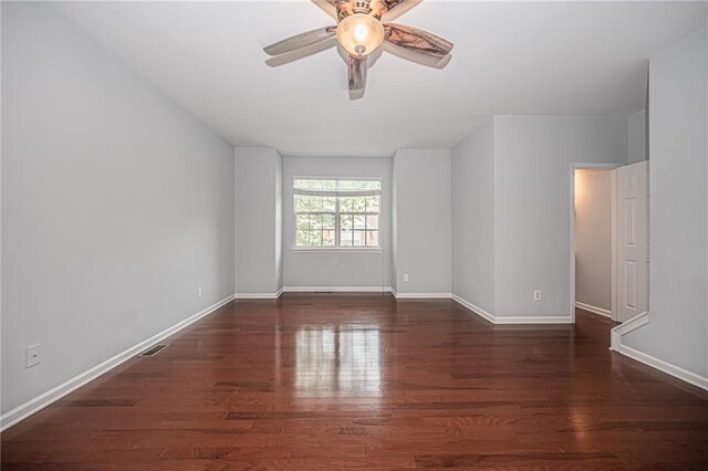 unfurnished room with ceiling fan and dark hardwood / wood-style flooring