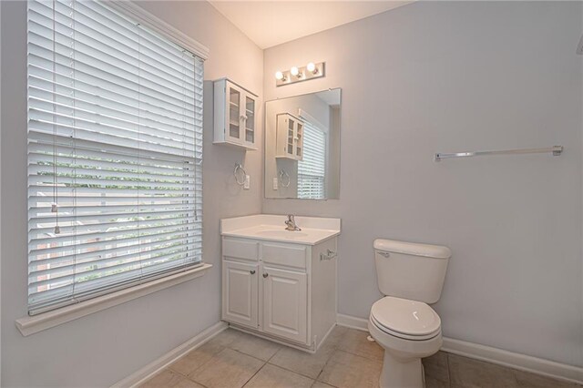 bathroom featuring tile patterned floors, vanity, and toilet