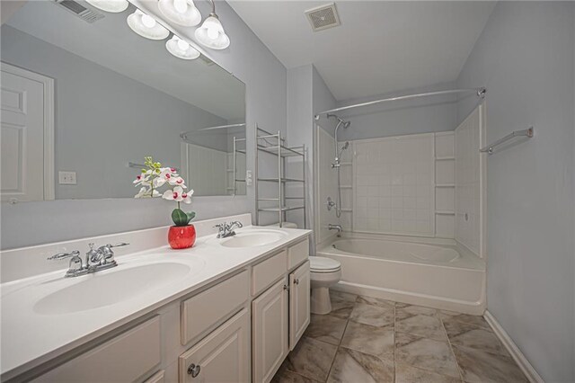 full bathroom with tub / shower combination, vanity, and toilet