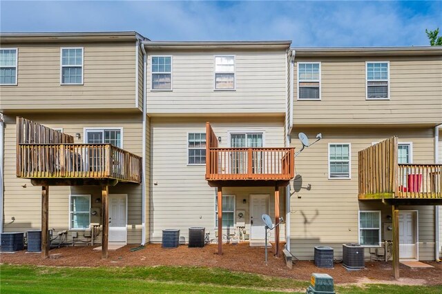 rear view of property featuring a balcony, a patio area, and central AC