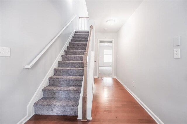 stairs featuring wood-type flooring