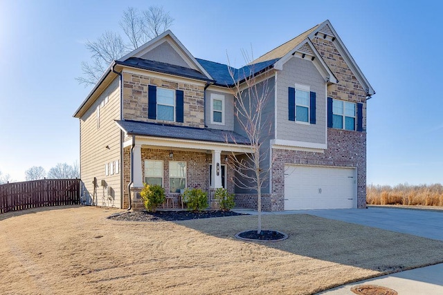 craftsman inspired home featuring a garage and covered porch