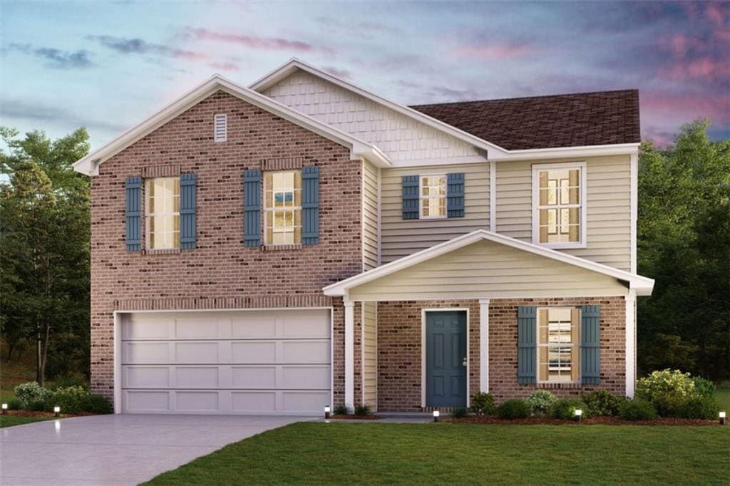 view of front facade with a yard, brick siding, a garage, and driveway