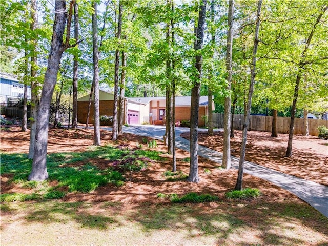 view of front of property featuring fence and a garage