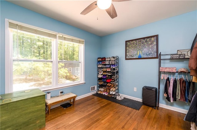 miscellaneous room with visible vents, wood finished floors, baseboards, and ceiling fan