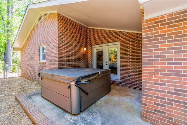 view of patio / terrace featuring french doors and a hot tub