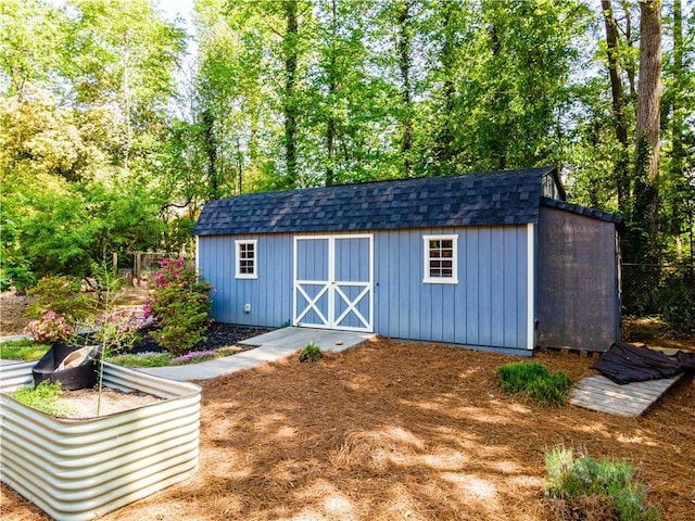view of shed featuring fence