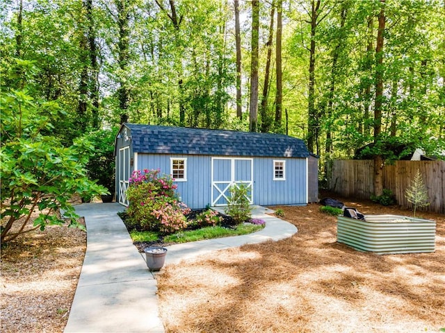 view of shed with fence