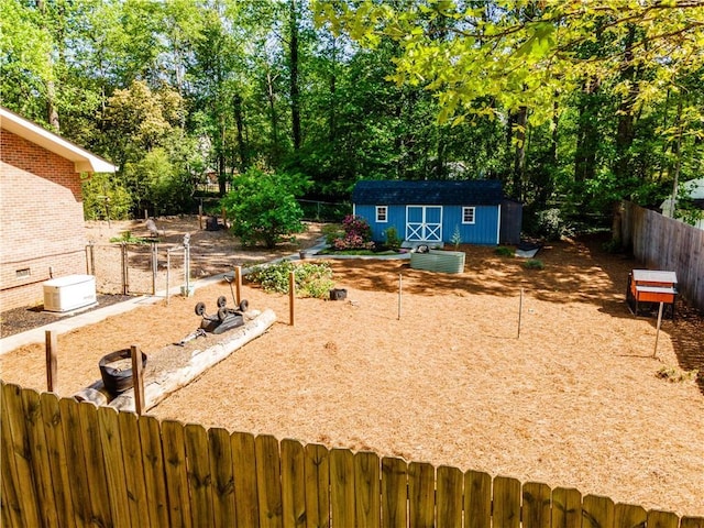view of yard featuring an outbuilding, a storage unit, and fence private yard
