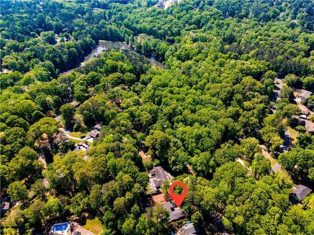 bird's eye view featuring a wooded view