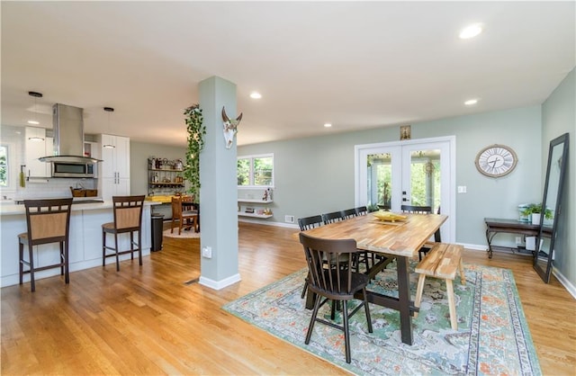 dining room with recessed lighting, light wood-style flooring, baseboards, and french doors