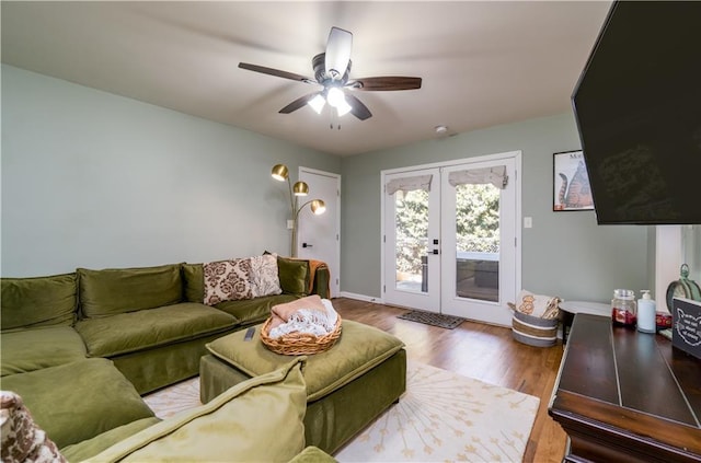 living room featuring baseboards, a ceiling fan, french doors, and wood finished floors