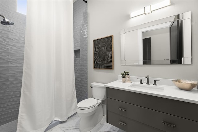 bathroom featuring toilet, vanity, and curtained shower