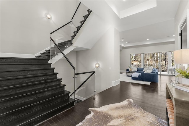 staircase with hardwood / wood-style floors