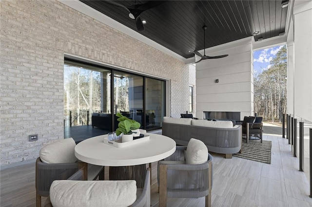 view of patio with ceiling fan and an outdoor living space