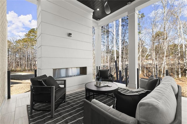 view of patio / terrace with ceiling fan and an outdoor living space