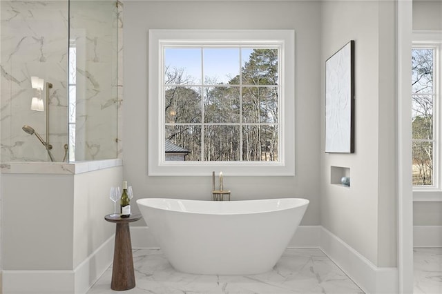 bathroom with shower with separate bathtub and plenty of natural light