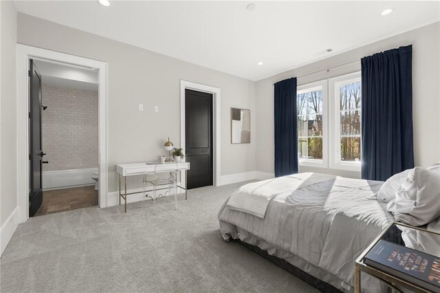 carpeted bedroom featuring ensuite bathroom