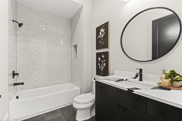 full bathroom featuring tile patterned floors, toilet, vanity, and tiled shower / bath