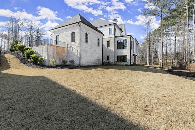 view of side of property featuring a yard