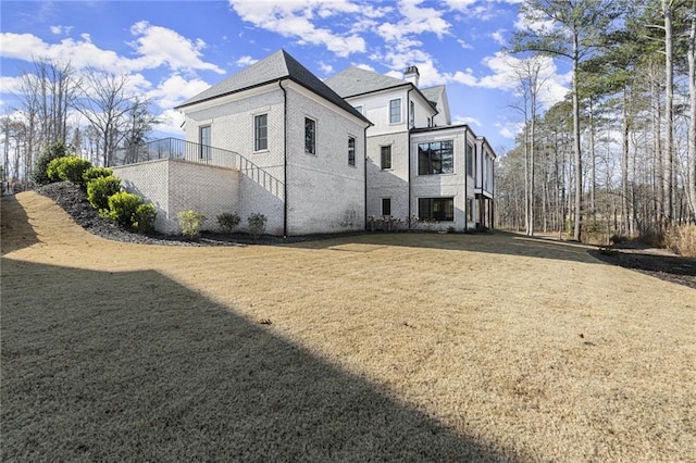 view of property exterior with a lawn