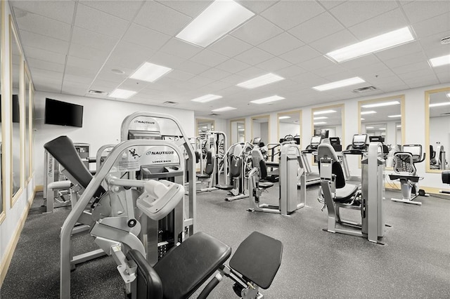 exercise room with a paneled ceiling