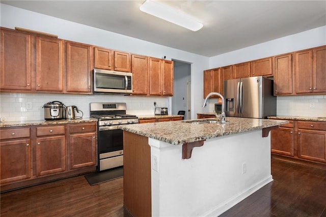 1612 Nations Trl, Riverdale, GA 30296 - kitchen featuring light stone countertops, a sink, stainless steel appliances, dark wood-type flooring, and backsplash