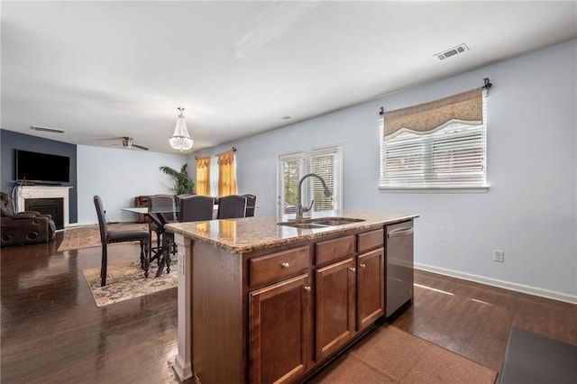 1612 Nations Trl, Riverdale, GA 30296 - kitchen with stainless steel dishwasher, visible vents, dark wood-style flooring, light stone countertops, and a sink