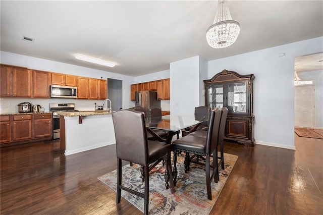 1612 Nations Trl, Riverdale, GA 30296 - dining area featuring baseboards, dark wood finished floors, an inviting chandelier, and visible vents