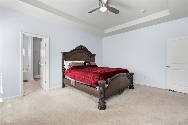 1612 Nations Trl, Riverdale, GA 30296 - carpeted bedroom with baseboards, connected bathroom, a raised ceiling, and a ceiling fan