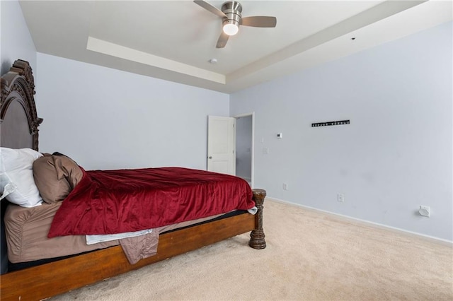 1612 Nations Trl, Riverdale, GA 30296 - carpeted bedroom featuring baseboards, ceiling fan, and a tray ceiling