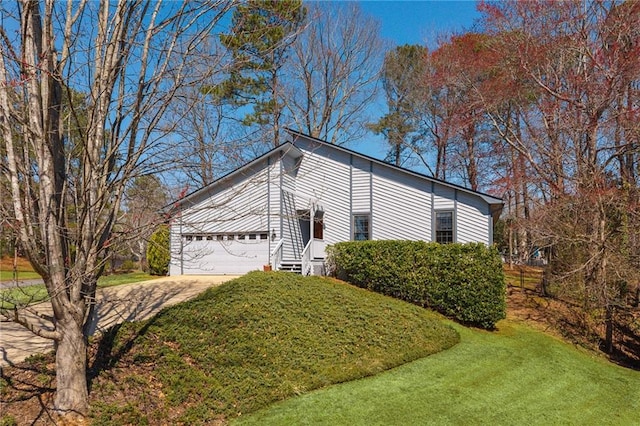 view of home's exterior featuring concrete driveway, an attached garage, and a lawn