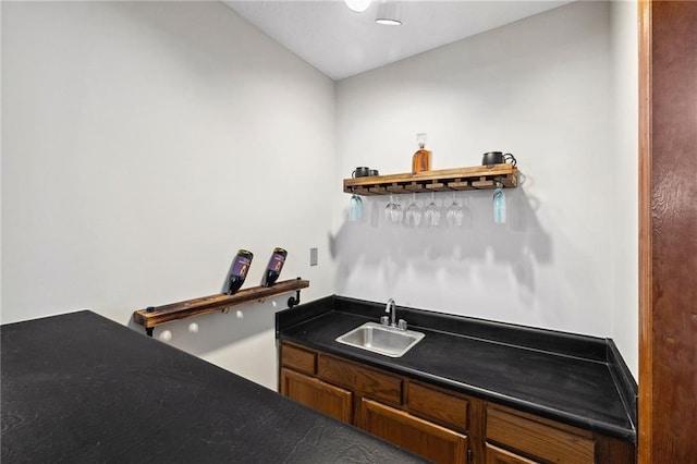 bar with wet bar and a sink