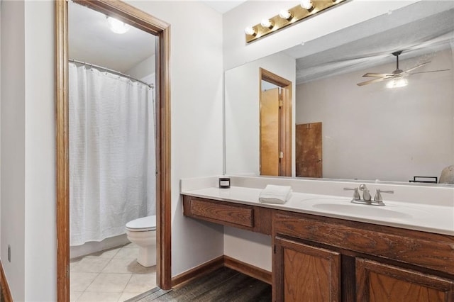 full bathroom with vanity, a shower with shower curtain, ceiling fan, tile patterned floors, and toilet