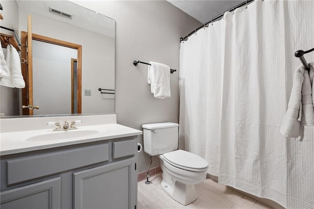 bathroom with visible vents, a shower with curtain, toilet, a textured ceiling, and vanity