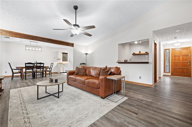 living room with baseboards, lofted ceiling, wood finished floors, and a ceiling fan