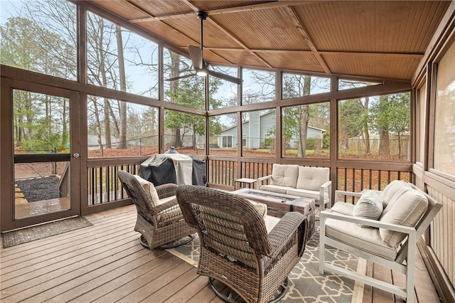 sunroom / solarium featuring wooden ceiling, a ceiling fan, and lofted ceiling