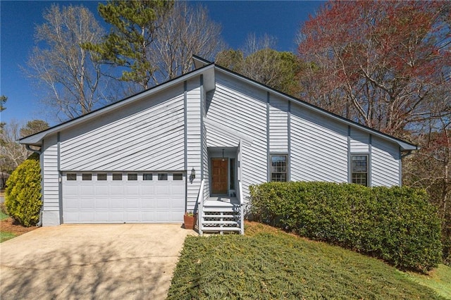 view of front of home featuring concrete driveway and a front yard