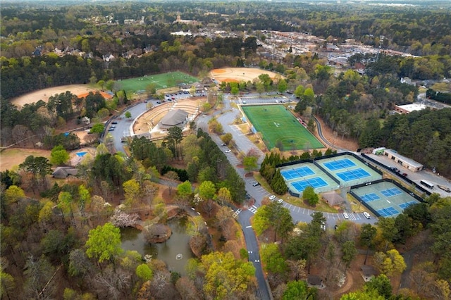 birds eye view of property with a view of trees